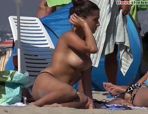 dark haired with flawless naked funbags on public beach