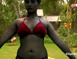 Inexperienced Indian gal in satin brassiere doing yoga